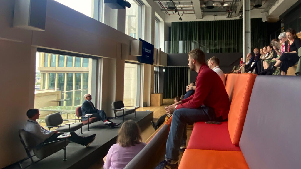 Group photo showing the seating area at Havas Village, with Keith Jones (Chair) and Neil Wood (Founder and COO) presenting.